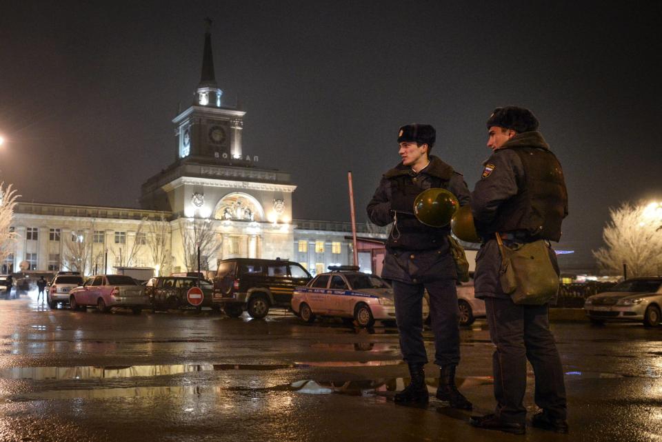 Interior Ministry members stand guard in front of the train station where a bomber detonated explosives in Volgograd