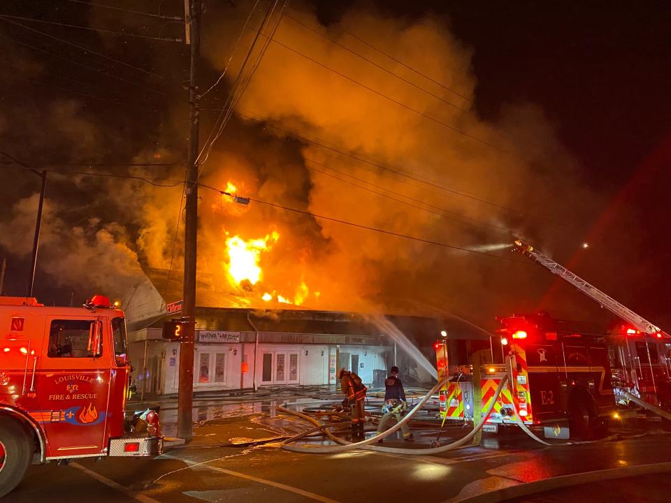 Firefighters in Louisville battle a fire that broke out early Wednesday morning at S. 18th and Jefferson streets. Dec. 21, 2022