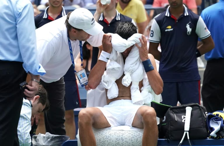 Feel the heat: Novak Djokovic takes a break from the heat against Marton Fucsovics