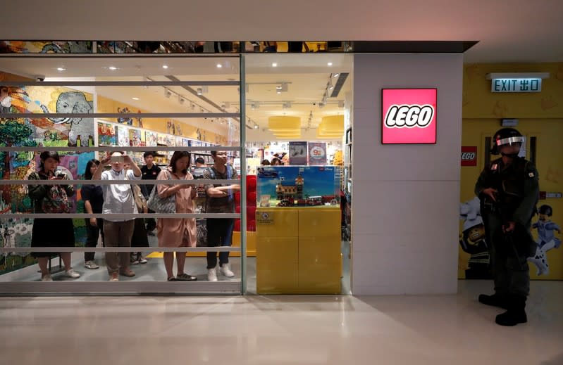 Shoppers and anti-government protesters gather at New Town Plaza in Sha Tin, Hong Kong