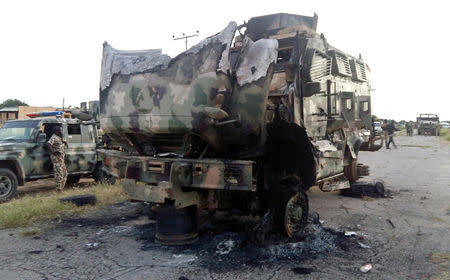 A damaged military vehicle is pictured in the northeast town of Gudumbali, after an attack by members of Islamic State in West Africa (ISWA), Nigeria September 11, 2018. Picture taken September 11, 2018. REUTERS/Kolawole Adewale