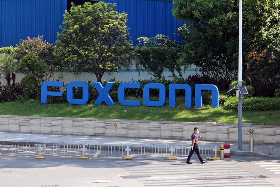 SHENZHEN, CHINA - SEPTEMBER 03 2022: A man passes by a compound of the electronics manufacturer Foxconn, which is under strict access control to prevent Covid-19, in Shenzhen in south China's Guangdong province Saturday, Sept. 03, 2022.