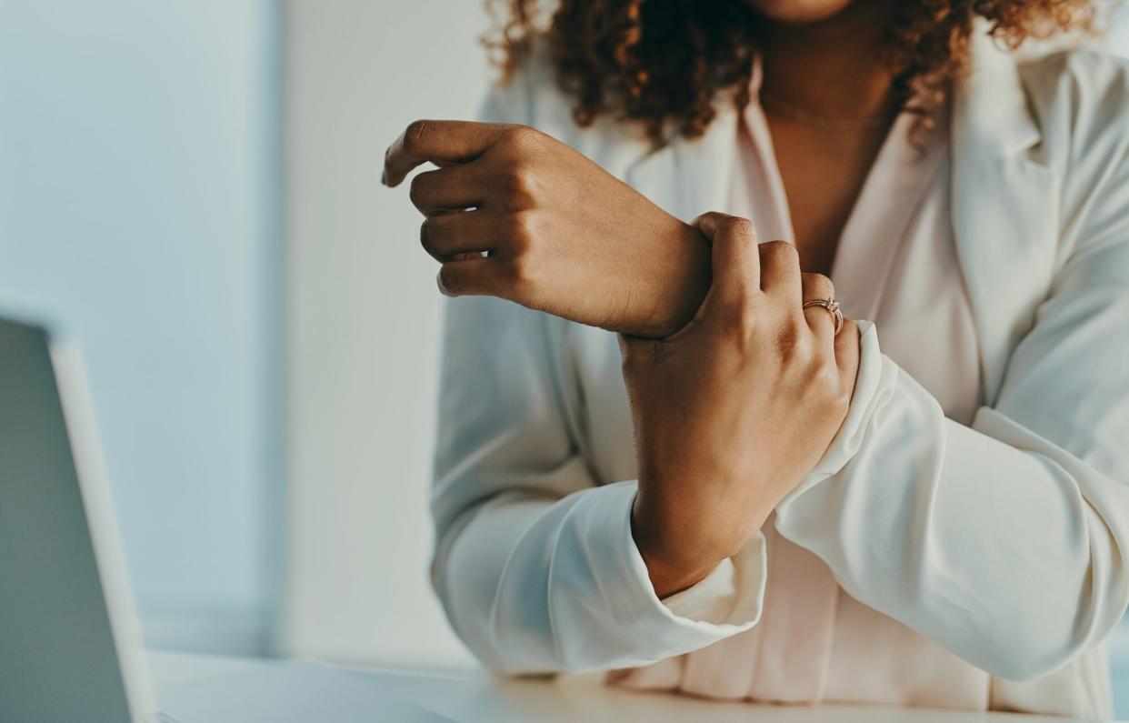 woman with arthritis grabbing wrist