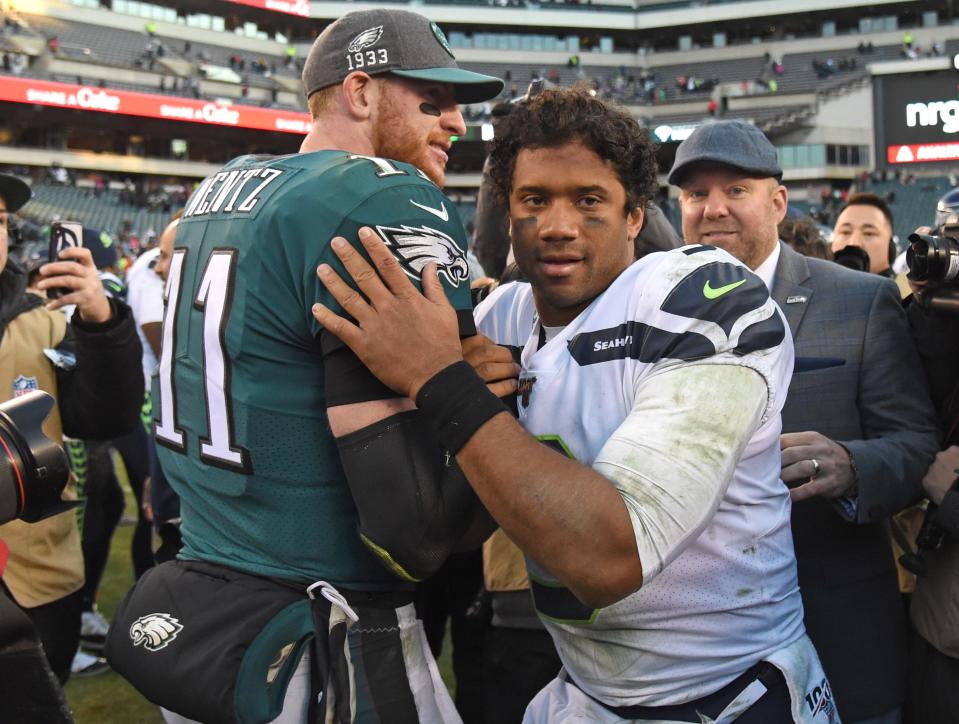 QBs Carson Wentz (11) and Russell Wilson will both don different uniforms in 2022.