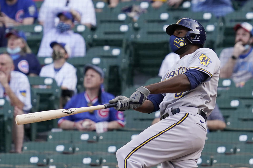 Milwaukee Brewers' Lorenzo Cain watches after hitting a three-run home run against the Chicago Cubs during the 10th inning of a baseball game in Chicago, Wednesday, April 7, 2021. (AP Photo/Nam Y. Huh)