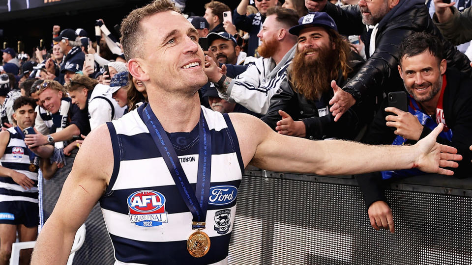 Joel Selwood high-fives fans as he walks around the MCG following Geelong's grand final win over Sydney.