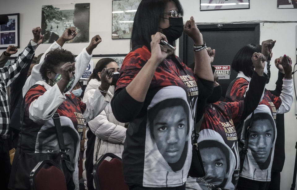 Attendees wear shirts with the image of Trayvon Martin and raise fists during singing at a rally commemorating the 10th anniversary of Martin's killing, Saturday Feb. 26, 2022, at National Action Network's Harlem headquarters in New York. Martin had been wearing a hoodie sweatshirt when he was fatally shot on his way back from a store while visiting his father in a gated community in the Orlando suburb. (AP Photo/Bebeto Matthews)