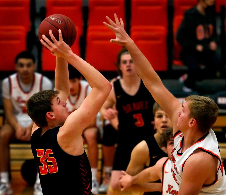 Kamiakin’s Tyler Bilodeau (35) gets his shot off under heavy pressure from Kennewick defender Nathan Knapik during their Jan. 18, 2022 game at Kennewick High School. Kamiakin won 62-55.