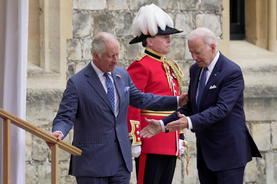 King Charles touches President Joe Biden's arm during a visit to Windsor Castle in 2023