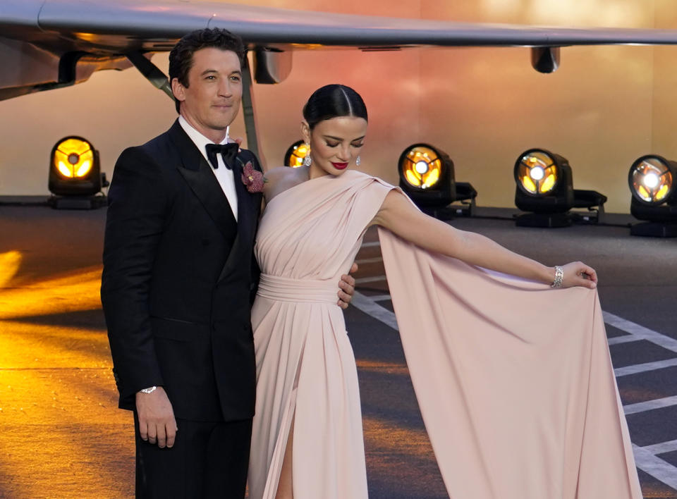 Miles Teller and his wife Keleigh Sperry pose for the media during the 'Top Gun Maverick' UK premiere at a central London cinema, on Thursday, May 19, 2022. (AP Photo/Alberto Pezzali)