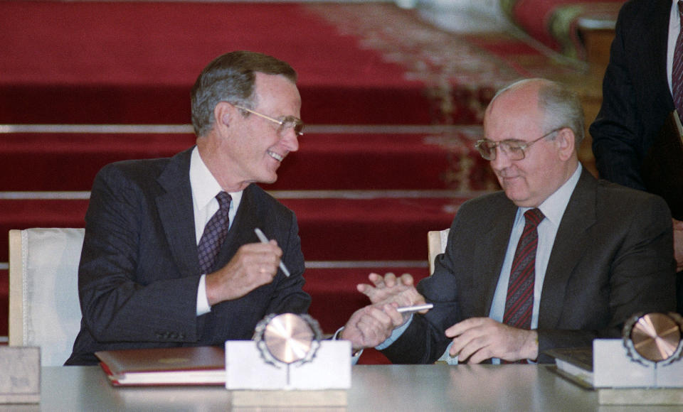 FILE - In this file photo taken Wednesday, Aug. 1, 1991, U.S. President George H. Bush and Soviet President Mikhail Gorbachev exchange pens after signing the START arms reduction treaty in the Kremlin, Moscow. Former Soviet premier Mikhail Gorbachev expressed his "deep condolences" Saturday Dec. 1, 2018, to the family of former U.S President George Bush and all Americans following his death, aged 94. (AP Photo/Boris Yurchenko)