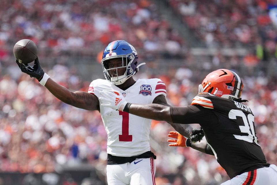 CLEVELAND, OHIO - SEPTEMBER 22: Malik Nabers #1 of the New York Giants passes the ball against Devin Bush #30 of the Cleveland Browns during the second quarter at Cleveland Browns Stadium on September 22, 2024 in Cleveland, Ohio. (Photo by Nic Antaya/Getty Images)