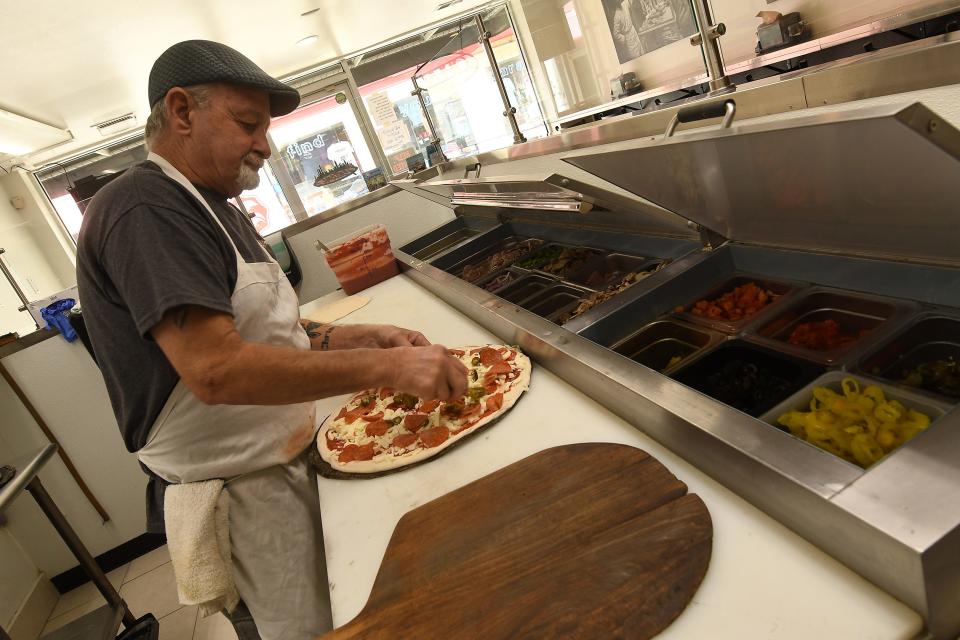 Tim O'Toole makes pizza at Fentoni's on the Boardwalk in Carolina Beach. The pizza shop was recently named the third best in North Carolina for New York-style pizza in the Washington Post. It was the only local pizza spot named in the piece that compared regional styles of pizza. KEN BLEVINS/STARNEWS