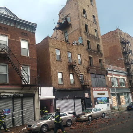 Firefighters are seen after the collapse of a building in Poughkeepsie, New York, U.S., June 18 2018, in this picture obtained from social media. Instagram/@slimty86/Tyrone Howell via REUTERS