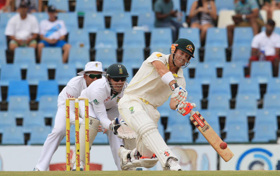 Australia's batsman David Warner, right, plays a stroke shot as South Africa's wicketkeeper AB de Villiers, centre, and captain Graeme Smith, left, watch on the third day of their their cricket Test match at Centurion Park in Pretoria, South Africa, Friday, Feb. 14, 2014. (AP Photo/ Themba Hadebe)