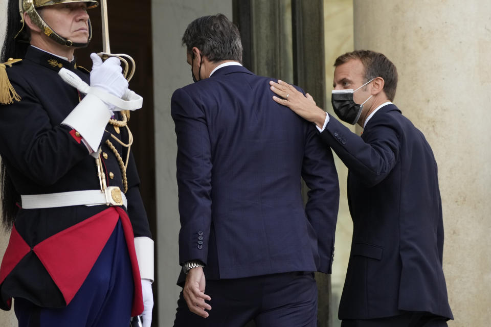 French President Emmanuel Macron, right, welcomes Prime Minister Kyriakos Mitsotakis Tuesday, Sept. 28, 2021 at the Elysee Palace in Paris. The leaders of Greece and France are expected to announce a major, multibillion-euro deal in Paris on Tuesday involving the acquisition by Greece of at least six French-built warships, Greek state ERT TV reported. (AP Photo/Francois Mori)