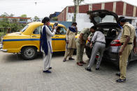 Policemen check vehicles on a road during the fourth phase of West Bengal state elections in Kolkata, India, Saturday, April 10, 2021. (AP Photo/Bikas Das)