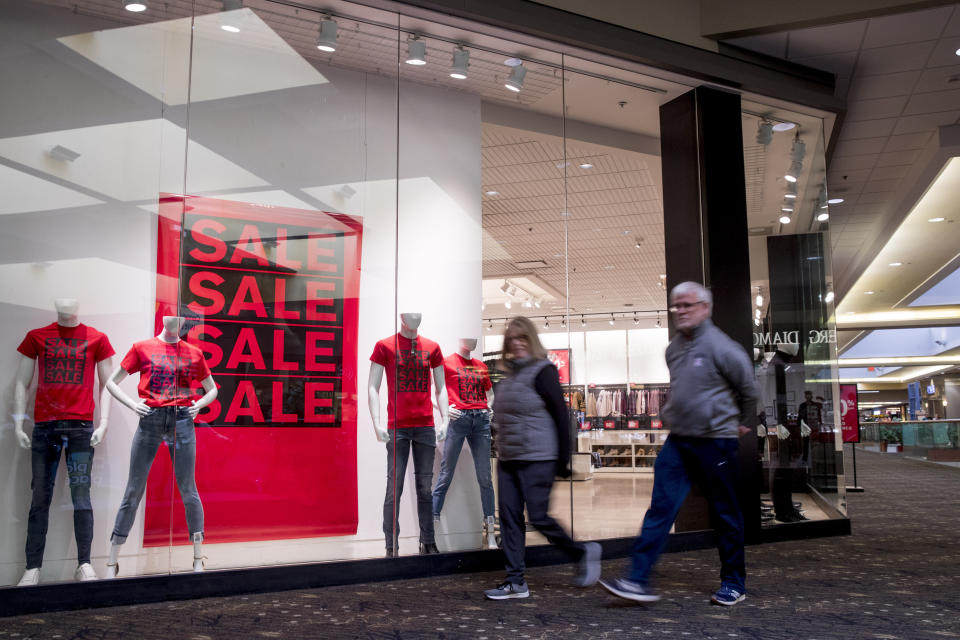 FILE - In this Jan. 22, 2020, file photo people walk by a retail clothing store in Valley West Mall in West Des Moines, Iowa. On Tuesday, Feb. 25, the Conference Board reports on U.S. consumer confidence for February. (AP Photo/Andrew Harnik, File)