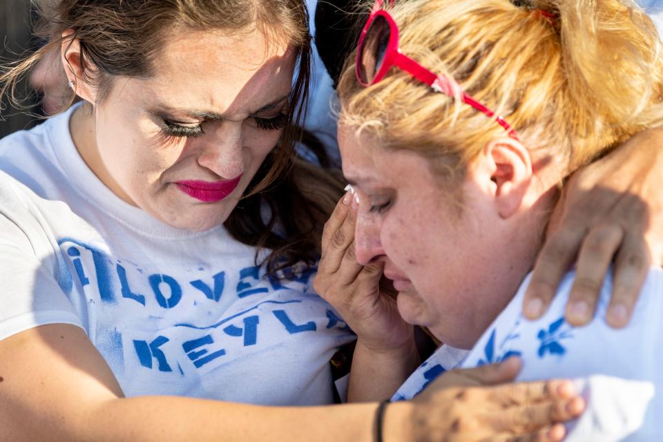 Keyla Salazar's mother Lorena de Salazar, right, and aunt Katiuska Pimentel, grieve as family and friends gather at Ace Empower Academy to remember Keyla, one of the victims of the shooting at the 2019 Gilroy Garlic Festival on Sunday.