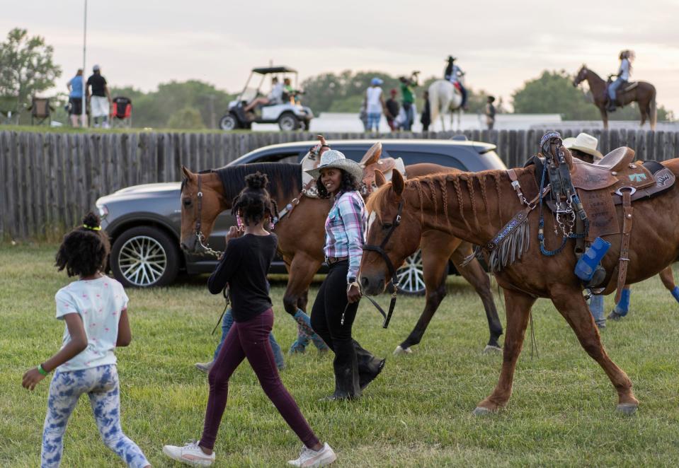 A group of young girls runs up to congratulate Staci Russell, 39, center, of Belleville, for her first place win in the barrel racing and talk to her as she walks her horse, Reese's Cup, back to her trailer during the 2023 Midwest Invitational Rodeo at the Wayne County Fairgrounds in Belleville on Saturday, June 10, 2023. Russell finished in first place for the second time during the two-day rodeo.