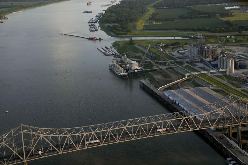 Barges sit docked at the Louis Dreyfus Holding Co Inc. along the Mississippi River, Friday, July 21, 2023, in Port Allen, La. In recent years, Louis Dreyfus and other commodity traders have scooped up millions of dollars’ worth of soy, corn and wheat straight from prison farms. (AP Photo/Gerald Herbert)