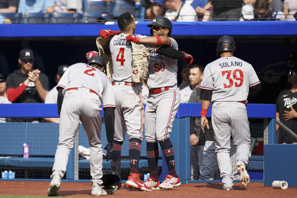 Minnesota Twins' Carlos Correa (4) celebrates with his teammates after hitting a grand slam against the Toronto Blue Jays during the eighth inning of a baseball game, Saturday, June 10, 2023, in Toronto. (Arlyn McAdorey/The Canadian Press via AP)