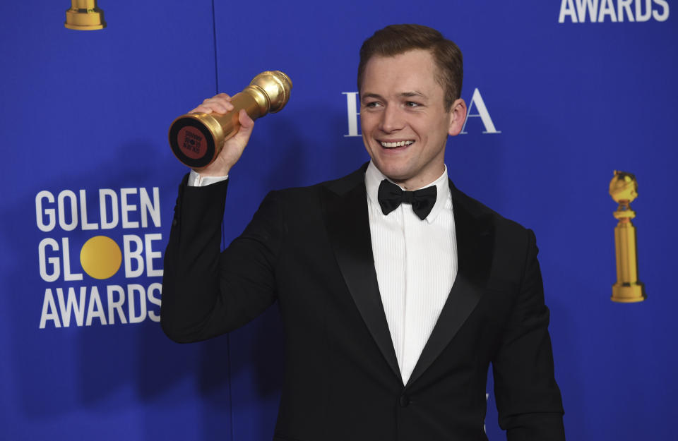 Taron Egerton poses in the press room with the award for best performance by an actor in a motion picture, musical or comedy, for "Rocketman" at the 77th annual Golden Globe Awards at the Beverly Hilton Hotel on Sunday, Jan. 5, 2020, in Beverly Hills, Calif. (AP Photo/Chris Pizzello)