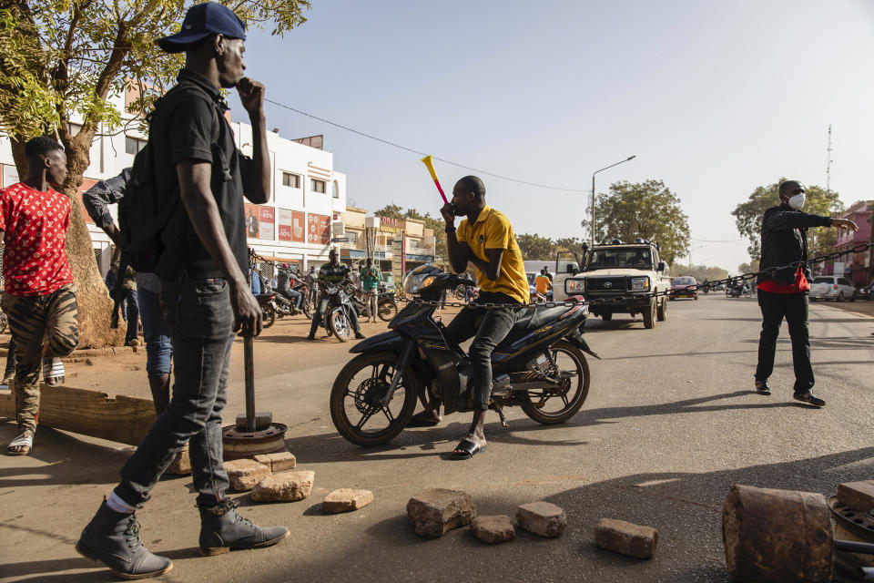 Protestors take to the streets of Burkina Faso's capital Ouagadougou Saturday Jan. 22, 2022, 27, 2021, protesting the government's inability to stop jihadist attacks spreading across the country and calling for President Roch Marc Christian Kabore to resign. (AP Photo/Sophie Garcia)