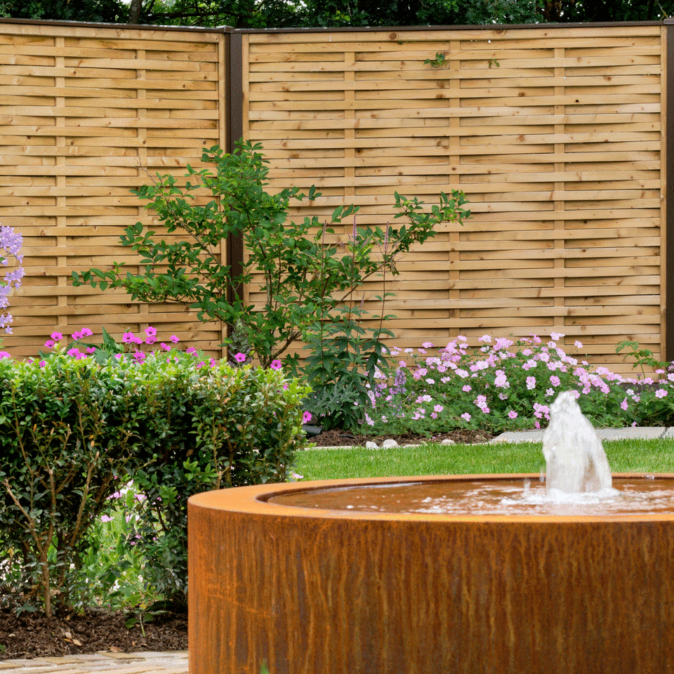 Country fence with fountain and lawn