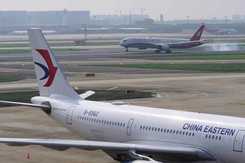 FILE PHOTO: A China Eastern Airlines aircraft and a Shanghai Airlines aircraft are seen in Hongqiao International Airport in Shanghai