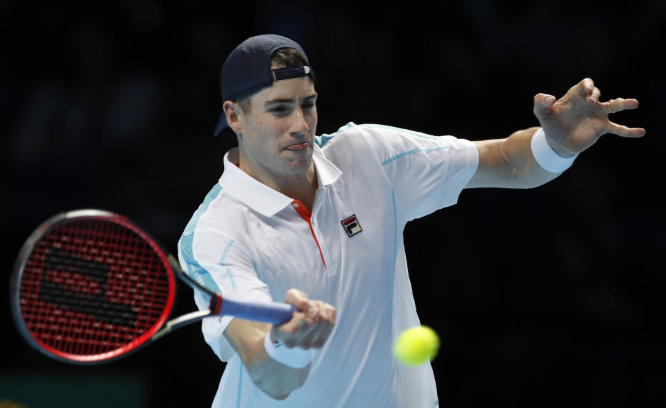 John Isner of the United States hits a retun to Marin Cilic of Croatia during their ATP World Tour Finals men's singles tennis match at the O2 arena in London, Wednesday, Nov. 14, 2018. (AP Photo/Alastair Grant)