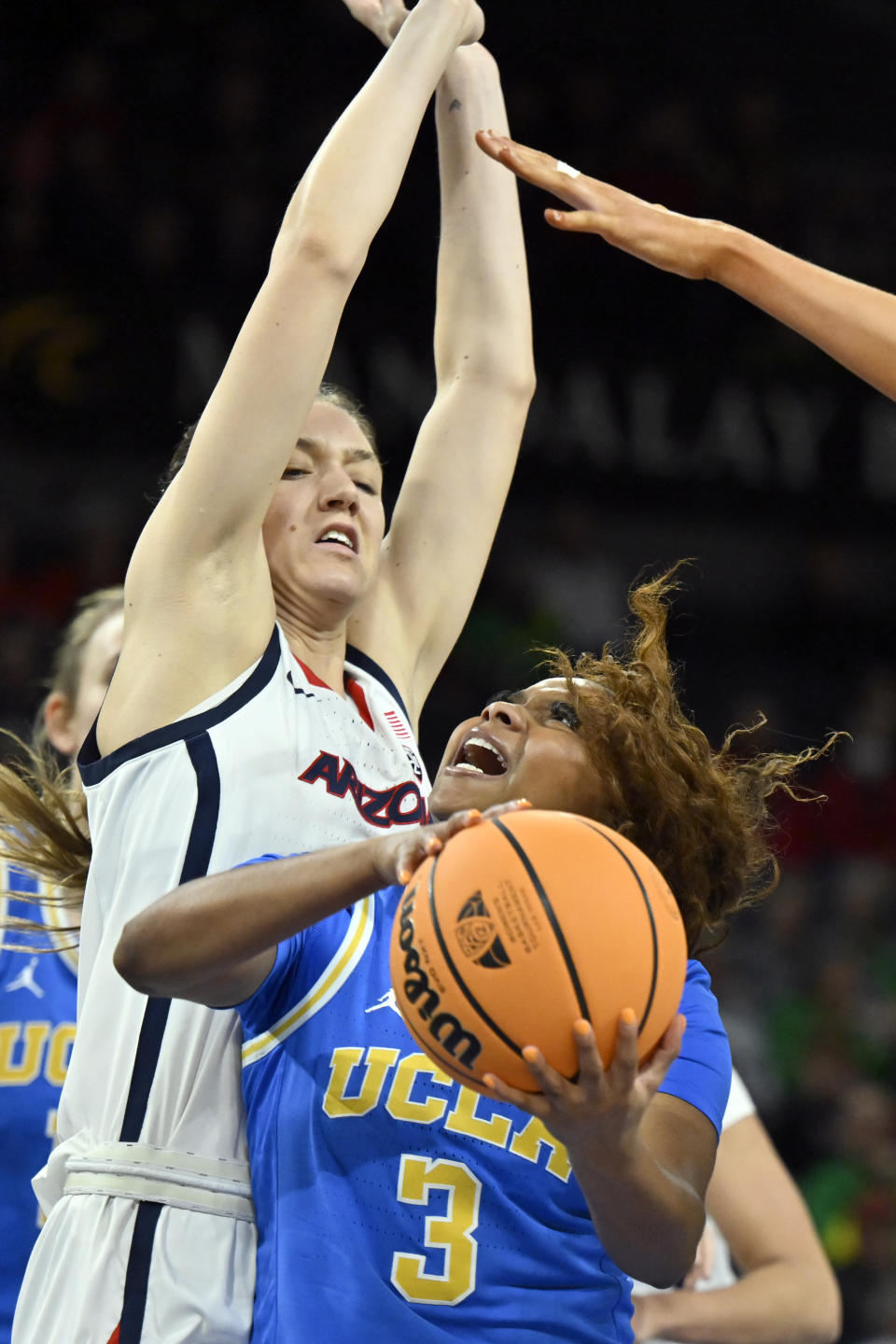 UCLA guard Londynn Jones (3) drives against Arizona guard Helena Pueyo during the first half of an NCAA college basketball game in the quarterfinal round of the Pac-12 women's tournament Thursday, March 2, 2023, in Las Vegas. (AP Photo/David Becker)