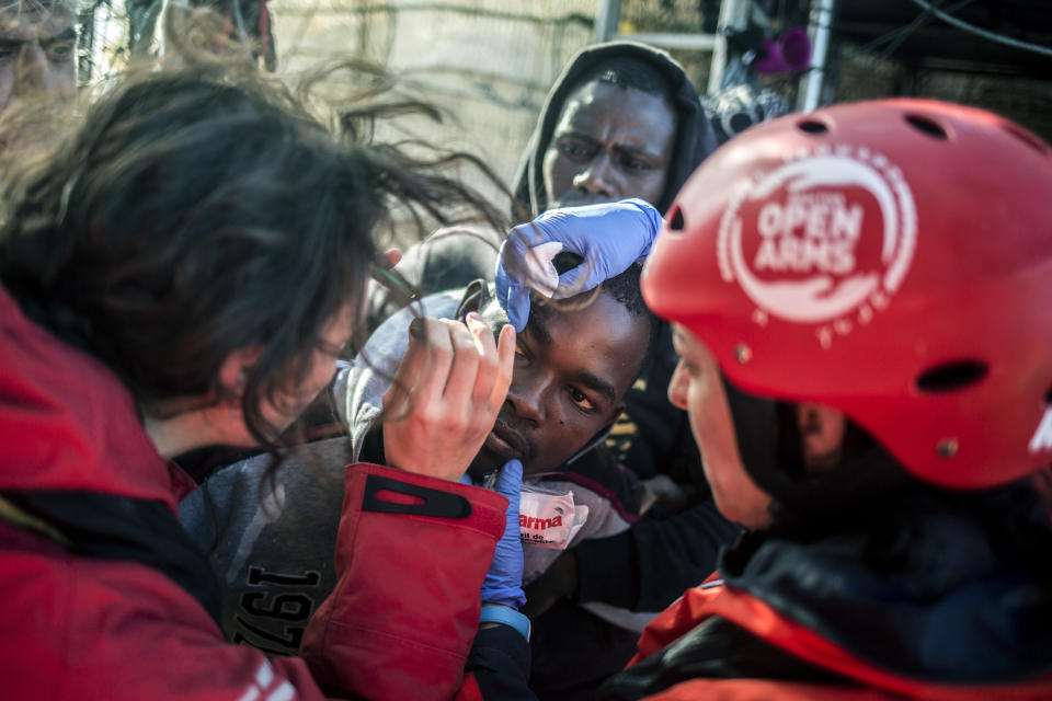 In this photo taken on Saturday, Nov. 24, 2018 photo, a migrant receives medical assistance after being rescued by Nuestra Madre de Loreto, a Spanish fishing vessel, two days ago north of the Libyan shore. The Spanish NGO Proactiva Open Arms carried medical checks and provided food, clothes and blankets to the migrants. (AP Photo/Javier Fergo)