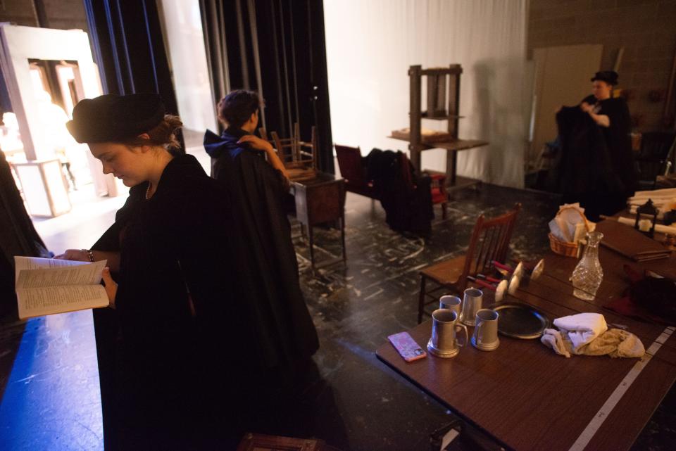 Behind the scenes inside the school auditorium, Washburn Rural actors Raegan Jacobs, Margrace McWright and Taylor Moore review their lines and ready their props during a rehearsal of "The Book of Will" Friday.