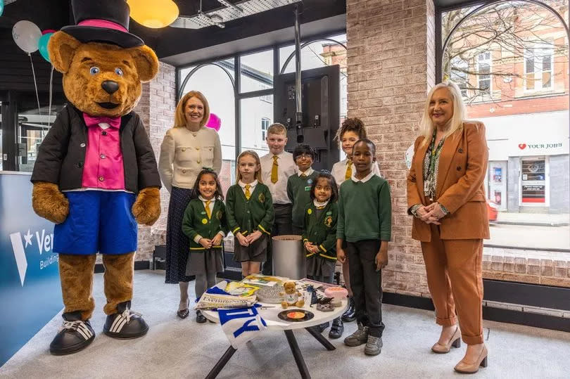 Vernon Bear, headteacher and pupils from St Joseph's Catholic Primary School alongside the time capsule items.