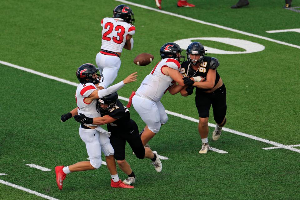 Creekside's Sean Ashenfelder (2), from left, throws the ball before being sacked by Richmond Hill's Gabe Bauman (21) as Creekside's Aiden Bringman (71) defends against Richmond Hill's Tad Christman (92) and Creekside's Harrison Garrido (23) runs his route during the second quarter of the Florida-Georgia Border Classic high school football matchup Saturday, Sept. 9, 2023 at Glynn County Stadium in Brunswick, Ga. The Richmond Hill Wildcats defeated the Creekside Knights 43-31. [Corey Perrine/Florida Times-Union]