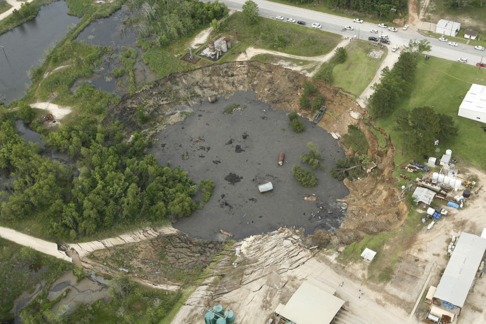 FILE- This aerial image shows a massive sinkhole near Daisetta, Texas, Wednesday afternoon, May 7, 2008. Earlier this month, Daisetta officials announced the sinkhole, which had first emerged in 2008 but had been dormant since then, had started to again expand. Officials say they're monitoring the new growth and keeping residents informed. (James Nielsen/Houston Chronicle via AP, File)
