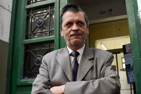 Professor Ricardo Berlot, who was a teacher of the five Argentine citizens of Rosario who were killed, reacts as he talks to journalists outside the Instituto Politecnico in Rosario, Argentina. REUTERS/Stringer