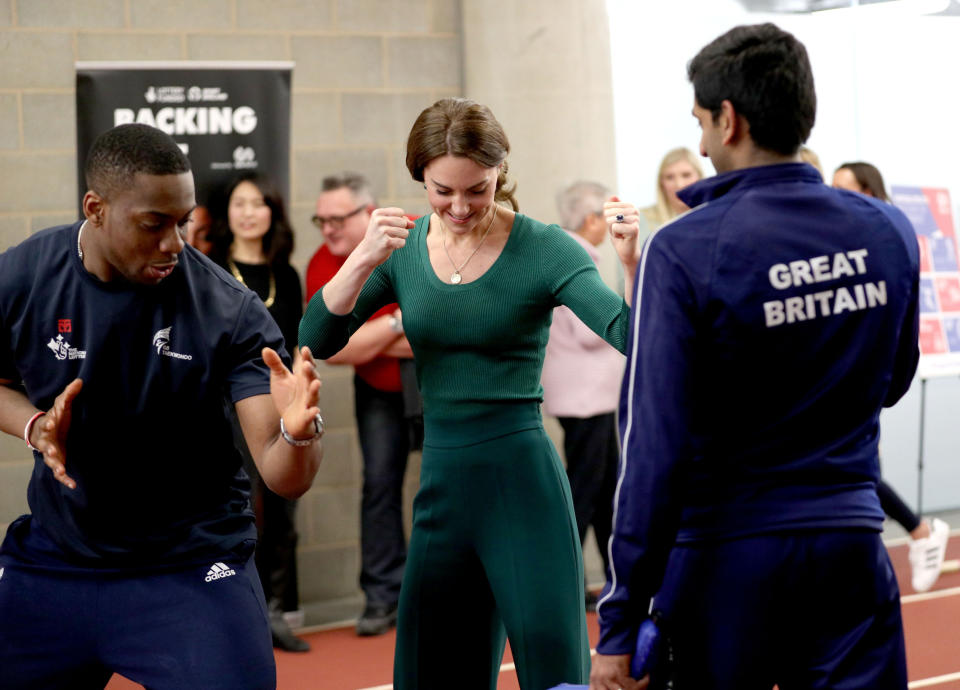 Britain's Catherine, Duchess of Cambridge (C), is shown Taekwondo moves by Britain's Lutalo Muhammad (L) during a SportsAid event at the London Stadium in east London on February 26, 2020. (Photo by Yui Mok / POOL / AFP) (Photo by YUI MOK/POOL/AFP via Getty Images)