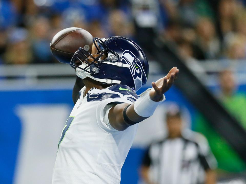 Geno Smith celebrates after scoring a touchdown against the Detroit Lions.