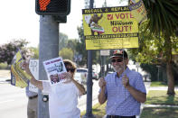 Supporters of the California recall of Gov. Gavin Newsom hold signs outside of a debate by Republican gubernatorial candidates at the Richard Nixon Presidential Library Wednesday, Aug. 4, 2021, in Yorba Linda, Calif. Newsom faces a Sept. 14 recall election that could remove him from office. (AP Photo/Marcio Jose Sanchez)