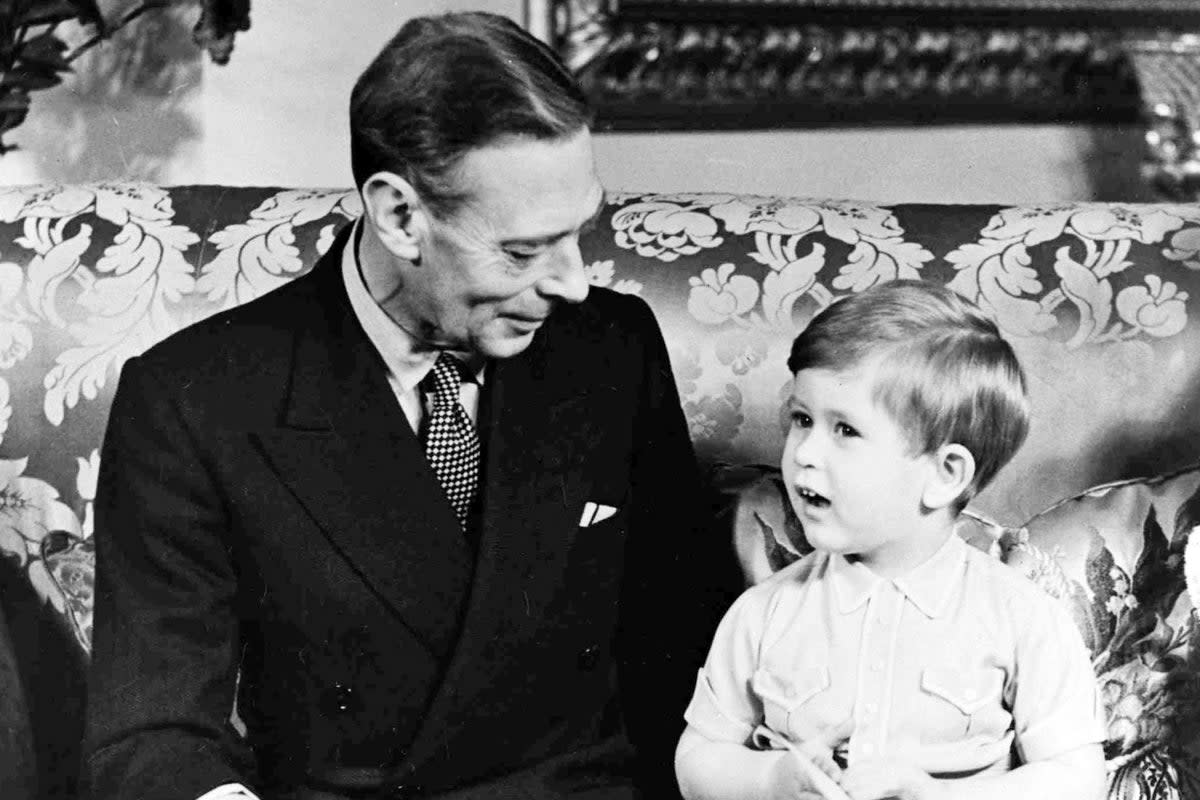 King George VI with his grandson Prince Charles celebrating his third birthday at Buckingham Palace, London  (PA)