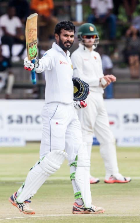 Sri Lanka batsman Upul Tharanga raises his bat in celebration of his century on October 30, 2016