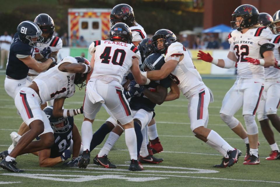 The Ball State defense wraps up a Georgia Southern runner during the game Saturday night at Paulson Stadium in Statesboro.