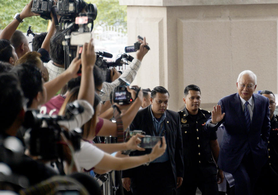 Former Prime Minister Najib Razak, right, arrives at Kuala Lumpur High Court in Kuala Lumpur, Malaysia, Wednesday, Dec. 12, 2018. Najib and Former 1Malaysia Development Berhad CEO, Arul Kanda Kandasamy, face fresh charges for tempering 1MDB audit report. (AP Photo/Yam G-Jun)