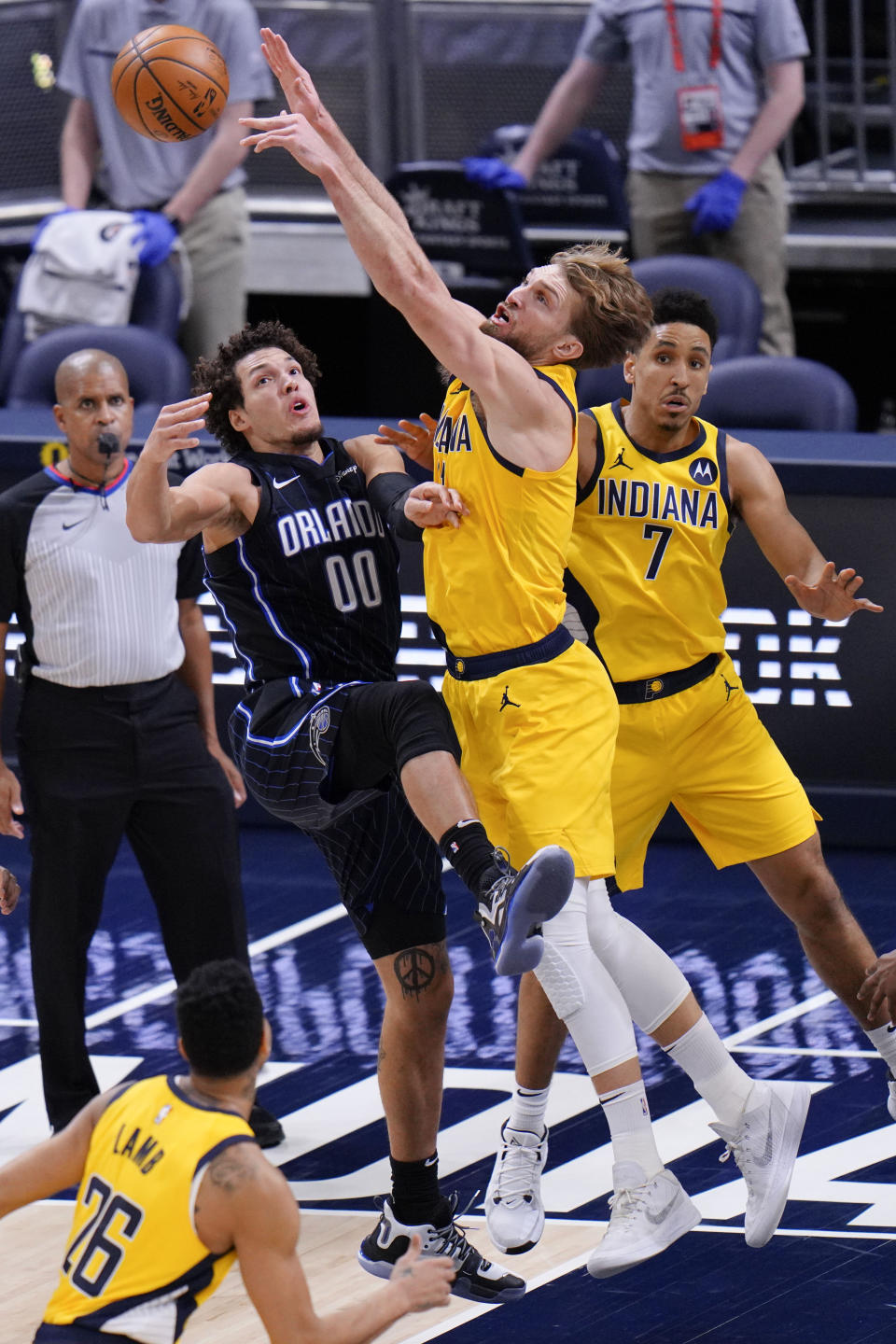 Indiana Pacers forward Domantas Sabonis (11) blocks a pass by Orlando Magic forward Aaron Gordon (00) during the second half of an NBA basketball game in Indianapolis, Friday, Jan. 22, 2021. (AP Photo/AJ Mast)