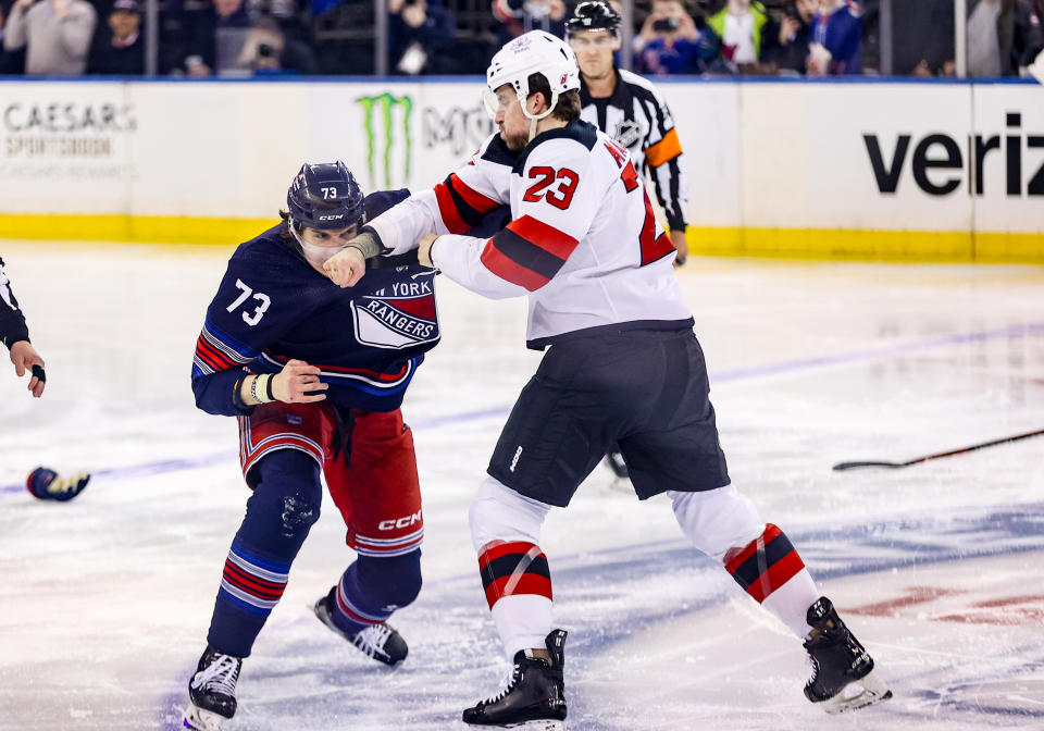 New York Rangers right wing Matt Rempe (73) gets punched by New Jersey Devils winger Kurtis MacDermid (23) during a game Wednesday in New York, NY. (Photo by Joshua Sarner/Icon Sportswire via Getty Images)