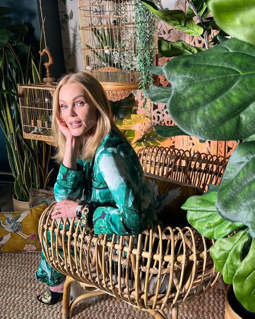 belinda carlisle green dress surrounded by plants