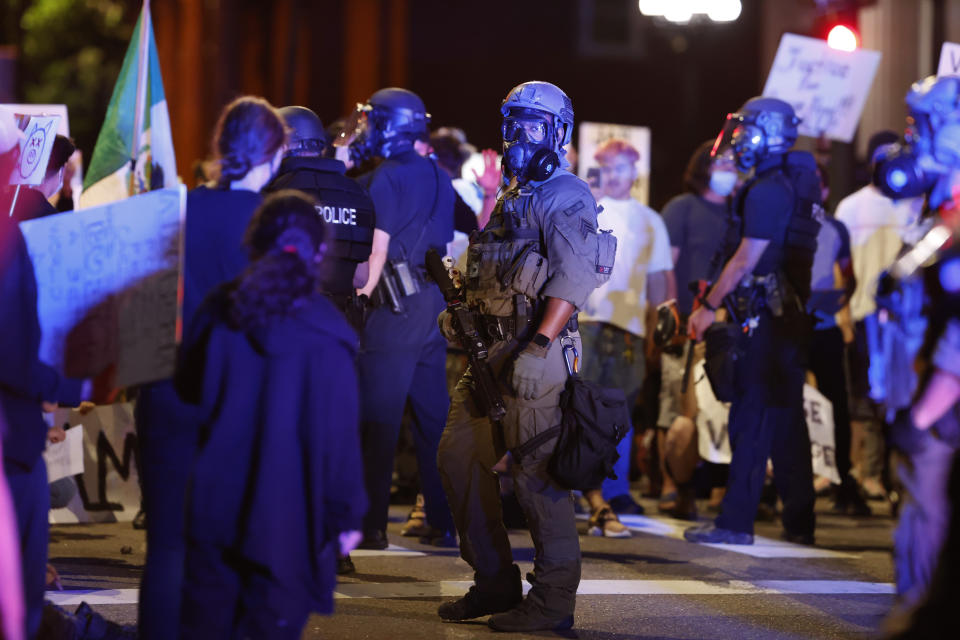 Denver police square off with protesters blocking an intersection during a demonstration outside the State Capitol over the Monday death of George Floyd, a handcuffed black man in police custody in Minneapolis, Thursday, May 28, 2020, in Denver. (AP Photo/David Zalubowski)