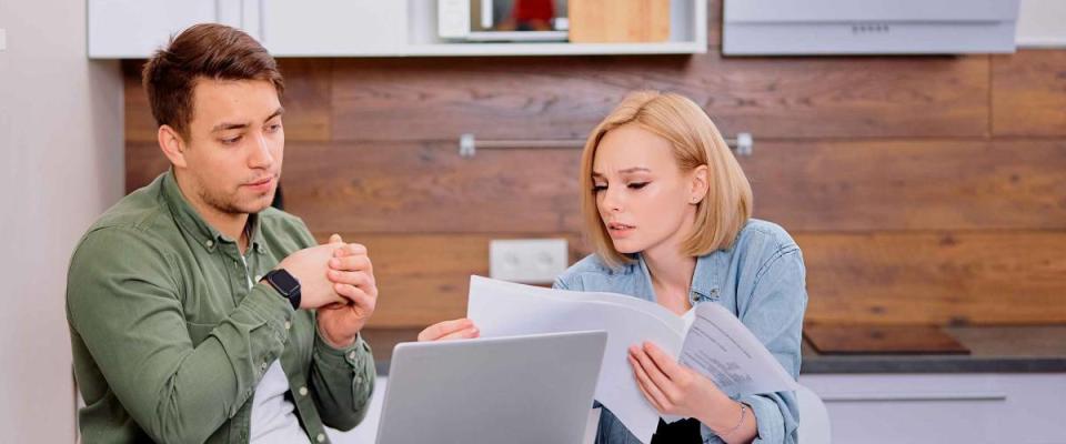 couple comparing mortgage rates sitting together at kitchen table